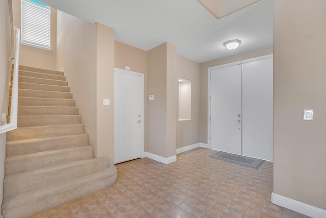 foyer entrance featuring light tile patterned floors