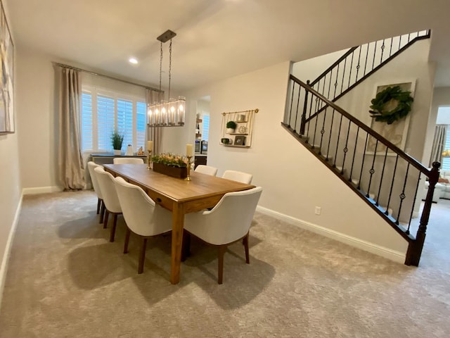 dining room featuring carpet floors and an inviting chandelier