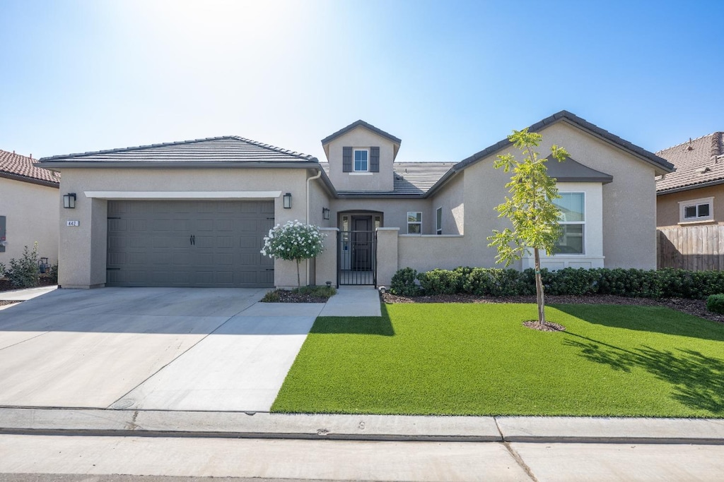 view of front of house with a front yard and a garage