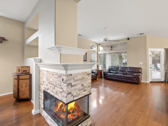 living room with hardwood / wood-style floors, a fireplace, and ceiling fan