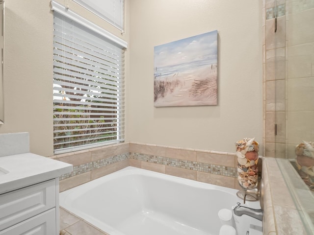 bathroom with vanity and a washtub