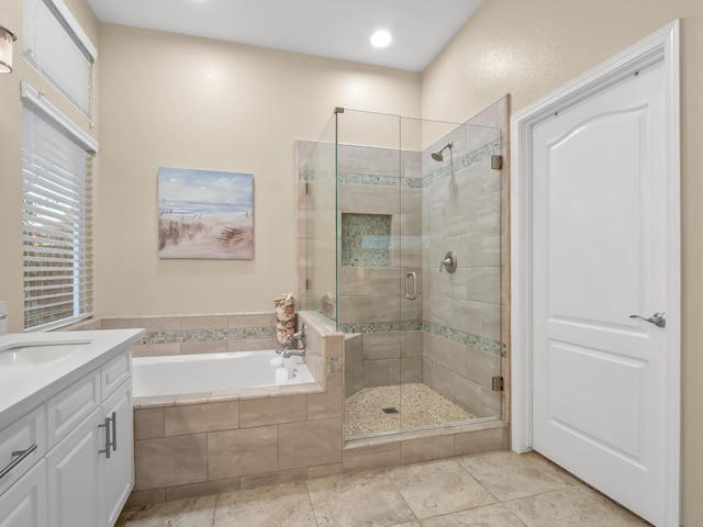 bathroom featuring vanity, shower with separate bathtub, and tile patterned floors