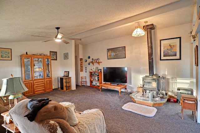 3363 S Anchor Ave, Orange Cove, CA 93646 - living area featuring a textured ceiling, a wood stove, a ceiling fan, and carpet floors