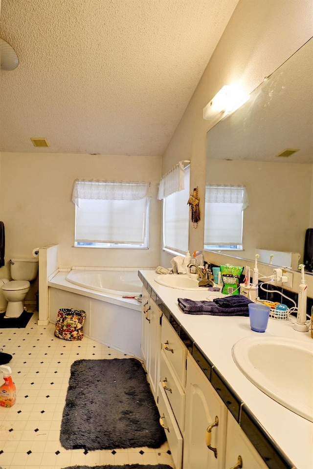 3363 S Anchor Ave, Orange Cove, CA 93646 - full bathroom featuring a textured ceiling, a garden tub, double vanity, and a sink