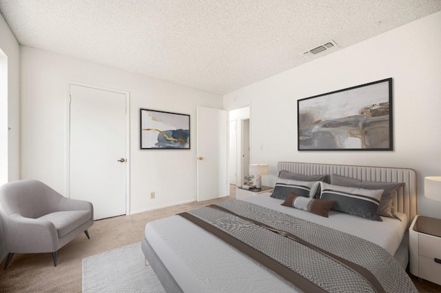 carpeted bedroom with a textured ceiling