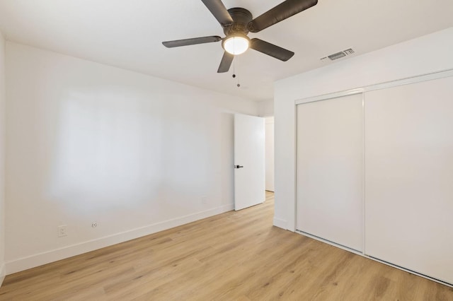 unfurnished bedroom with ceiling fan, a closet, and light hardwood / wood-style flooring