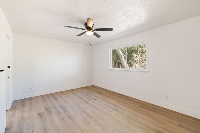 unfurnished room featuring ceiling fan, a textured ceiling, and light hardwood / wood-style flooring