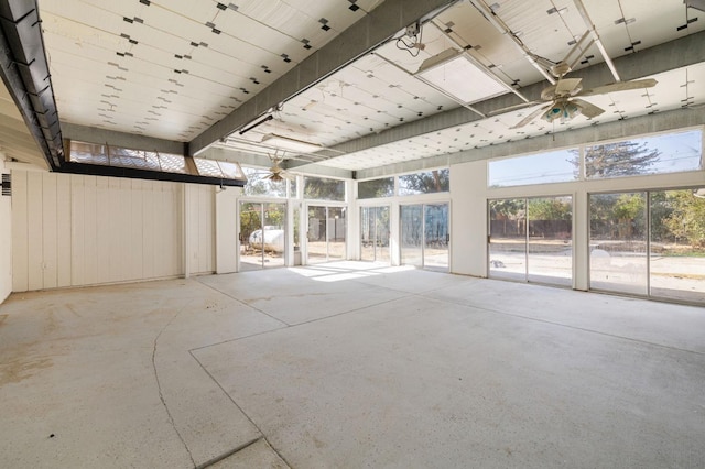 unfurnished sunroom with ceiling fan