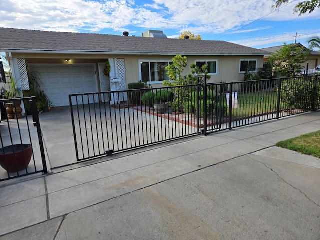 single story home featuring a garage, driveway, a fenced front yard, and stucco siding