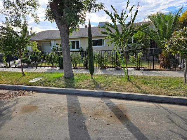 view of front of house with fence and stucco siding