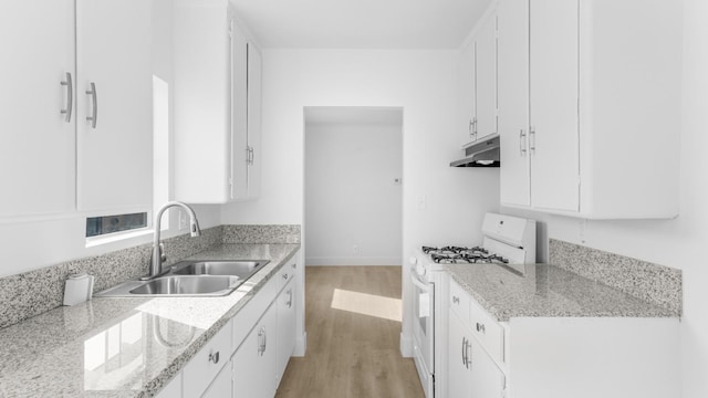 kitchen featuring white cabinetry, light hardwood / wood-style flooring, light stone counters, and white range with gas cooktop