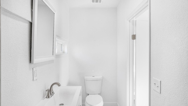 bathroom featuring sink and toilet