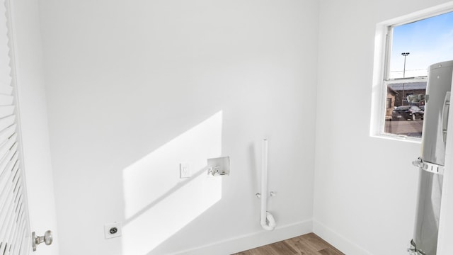 clothes washing area with wood-type flooring and electric dryer hookup