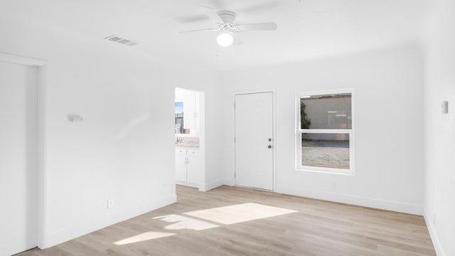 unfurnished room with ceiling fan and light hardwood / wood-style floors