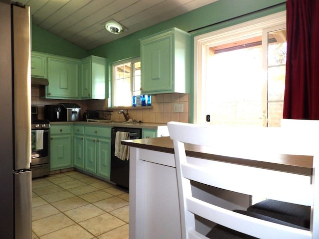 kitchen featuring a wealth of natural light, black dishwasher, backsplash, and stainless steel stove