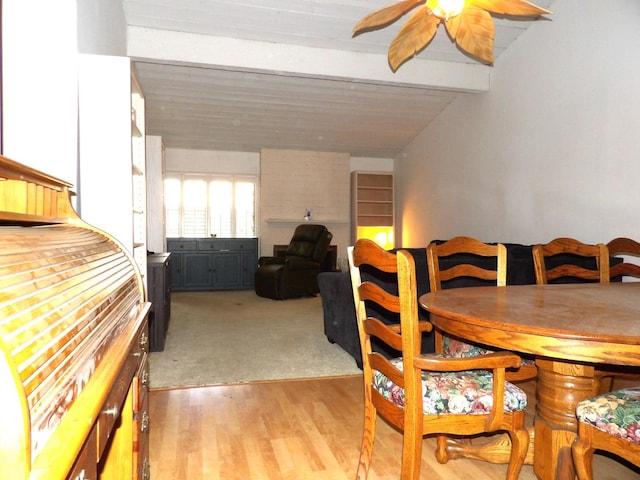 dining area with vaulted ceiling with beams, light hardwood / wood-style flooring, and ceiling fan