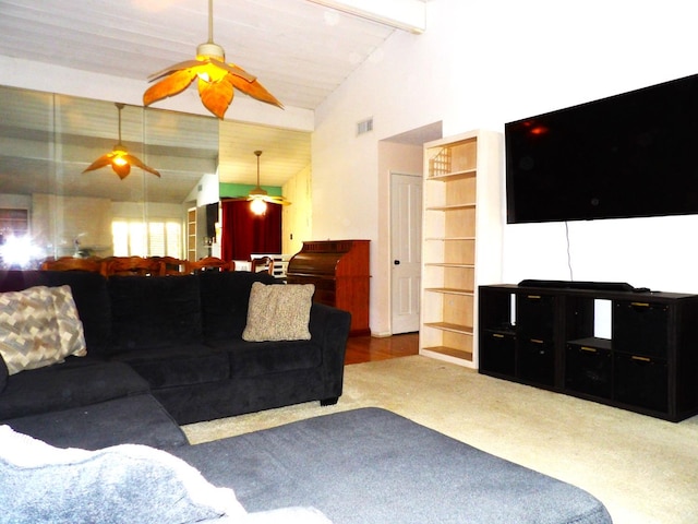 carpeted living room featuring beam ceiling and high vaulted ceiling