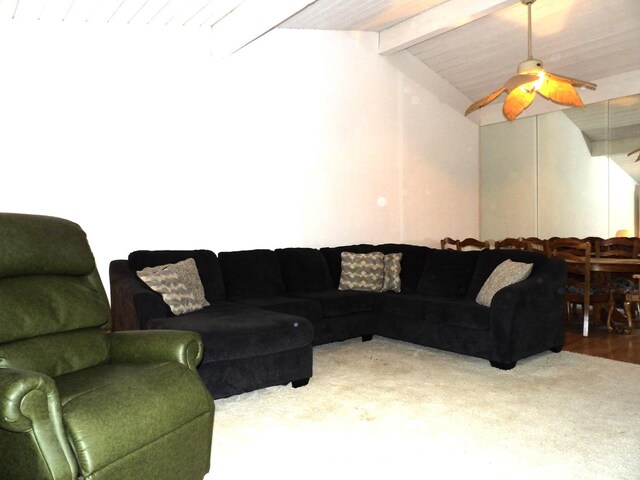 living room featuring ceiling fan, lofted ceiling with beams, and hardwood / wood-style floors