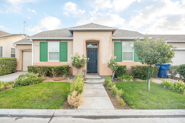 view of front of property with a front yard and a garage