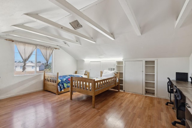 bedroom with hardwood / wood-style floors and vaulted ceiling with beams