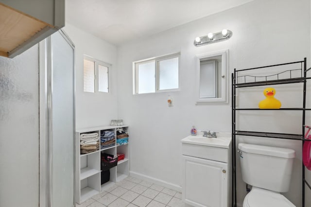 bathroom with toilet, vanity, tile patterned floors, and walk in shower