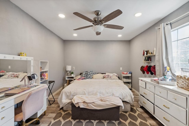 bedroom with light hardwood / wood-style floors and ceiling fan