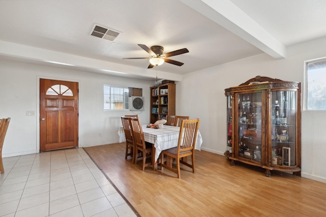 dining room with beamed ceiling, ceiling fan, and light wood-type flooring