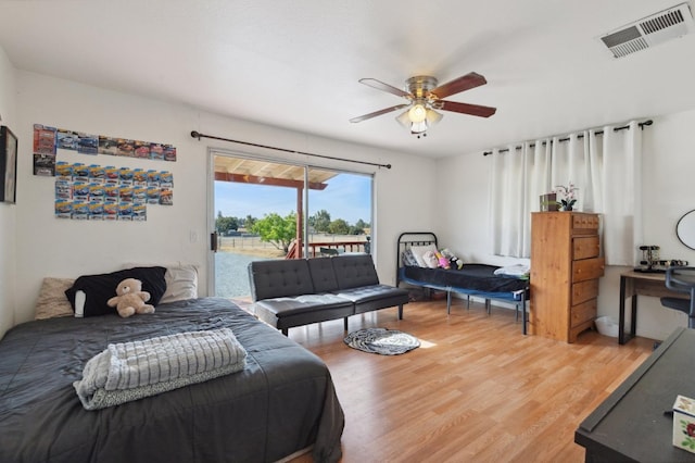 bedroom featuring access to outside, wood-type flooring, and ceiling fan