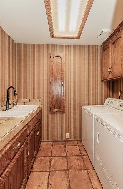 1531 E Avila, Tulare, CA 93274 - washroom with cabinet space, washing machine and clothes dryer, a sink, wallpapered walls, and visible vents