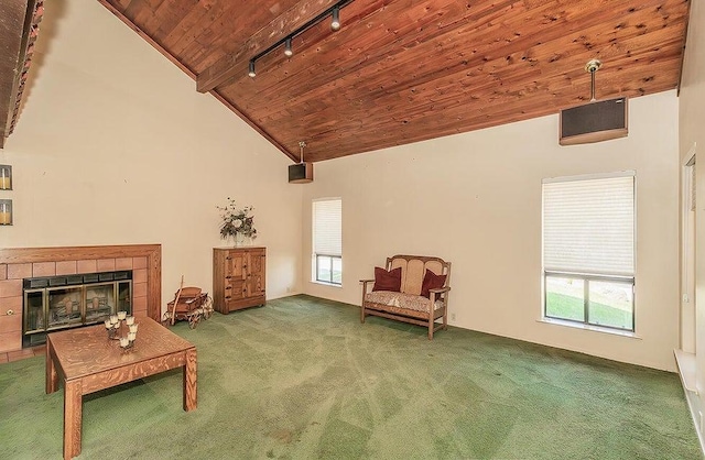 sitting room with beamed ceiling, wood ceiling, track lighting, carpet floors, and a fireplace