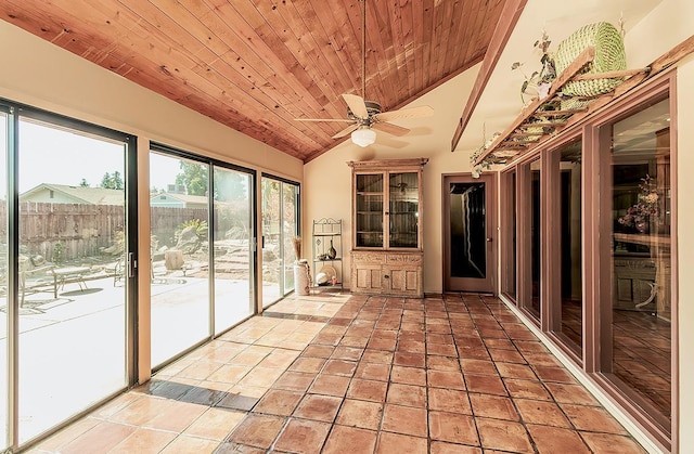 unfurnished sunroom with wood ceiling, vaulted ceiling, and ceiling fan