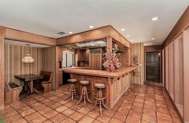 bar featuring hanging light fixtures and sink