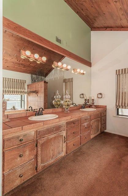 bathroom featuring vaulted ceiling, vanity, and wood ceiling