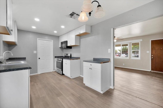 kitchen with white cabinetry, sink, ceiling fan, stainless steel gas range oven, and light hardwood / wood-style floors