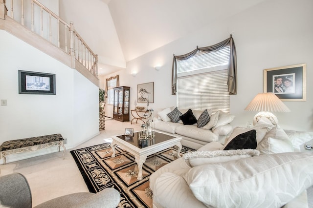 living room with carpet flooring and a towering ceiling