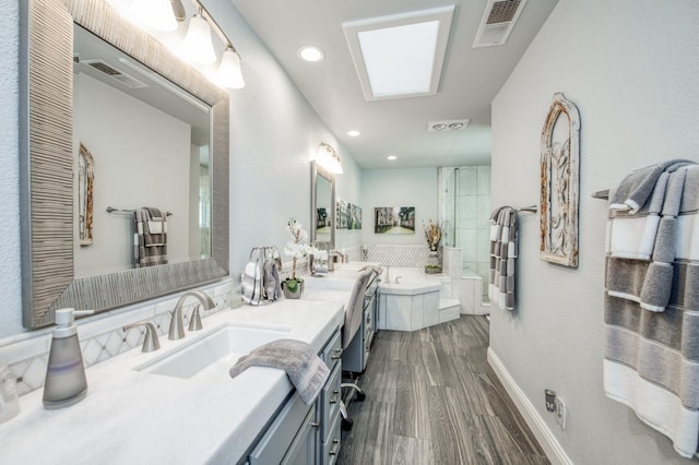 full bathroom with a sink, double vanity, recessed lighting, visible vents, and a garden tub