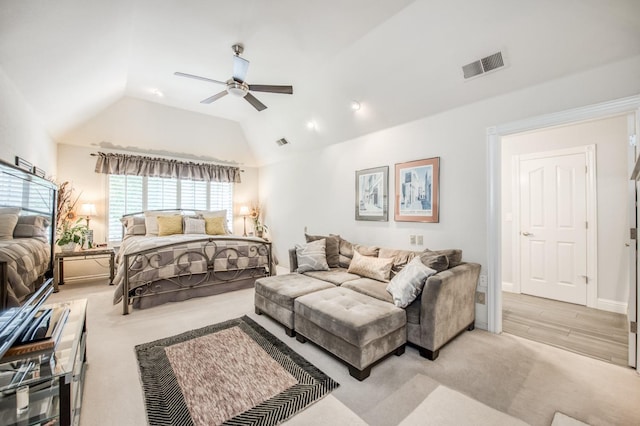 bedroom featuring carpet, visible vents, vaulted ceiling, and a ceiling fan