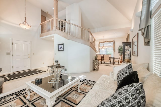 carpeted living room featuring high vaulted ceiling and a wealth of natural light