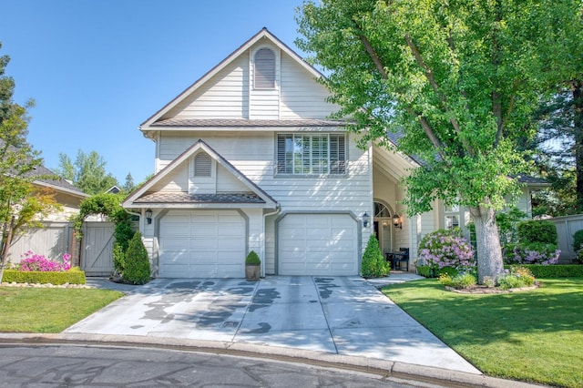 view of front property featuring a front lawn and a garage