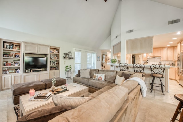 living area with high vaulted ceiling, recessed lighting, visible vents, and light tile patterned floors