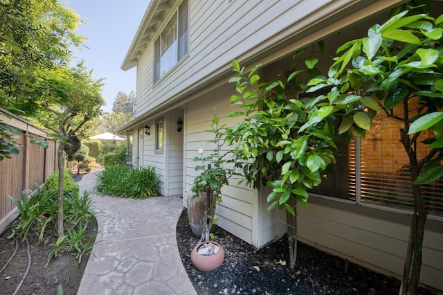 view of side of home with fence