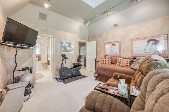 living room with track lighting, visible vents, carpet flooring, and vaulted ceiling