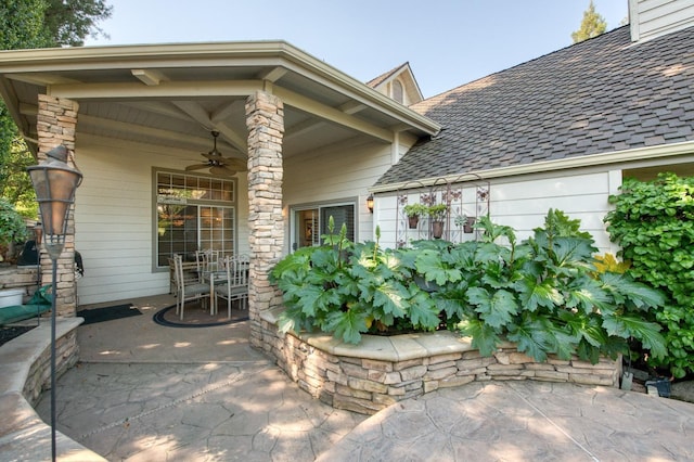 entrance to property with a patio area and ceiling fan