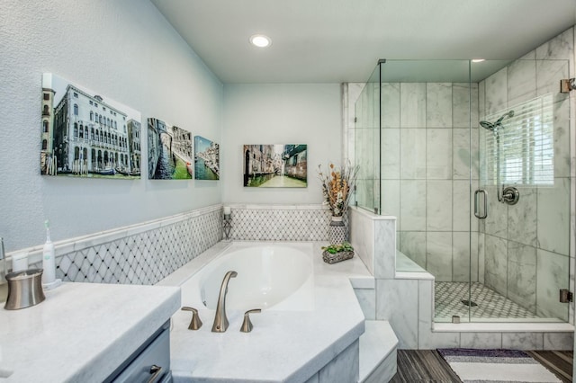 full bathroom featuring a shower stall, recessed lighting, vanity, and a bath