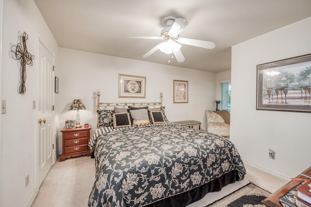 bedroom featuring light colored carpet and ceiling fan