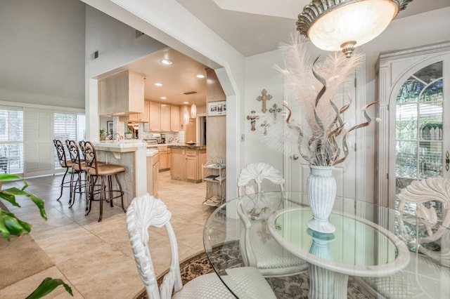 dining room featuring arched walkways and recessed lighting