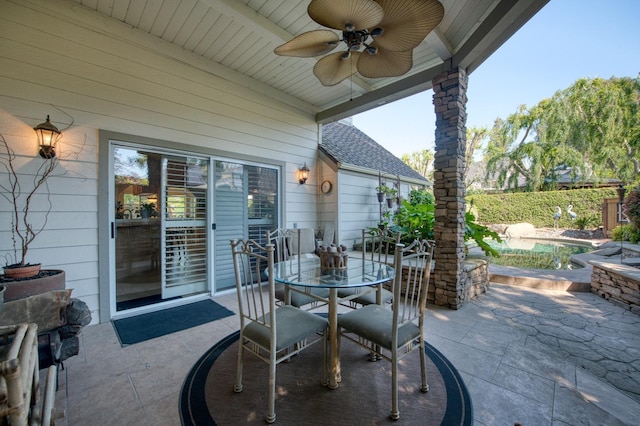 view of patio with outdoor dining space, a ceiling fan, and a fenced in pool