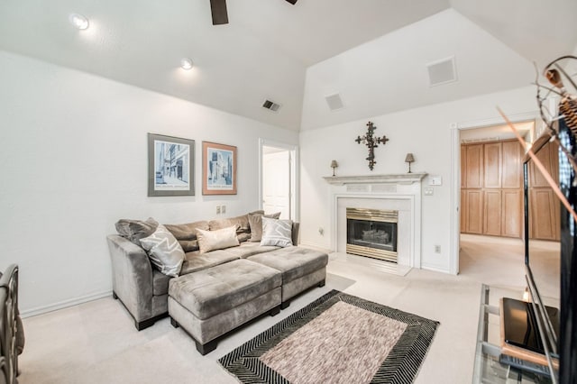 living area with visible vents, carpet flooring, ceiling fan, and vaulted ceiling