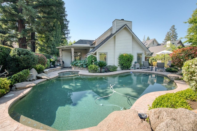 view of pool with an in ground hot tub and a patio area