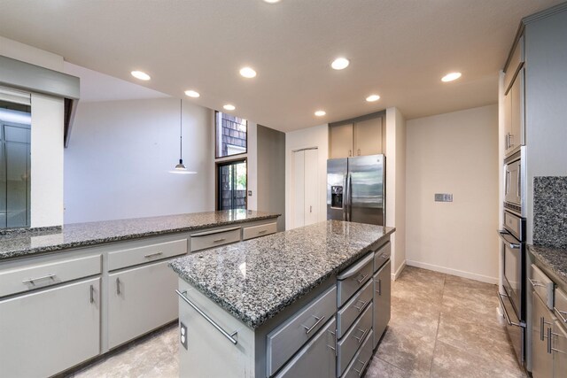 kitchen featuring gray cabinetry, recessed lighting, a center island, and appliances with stainless steel finishes